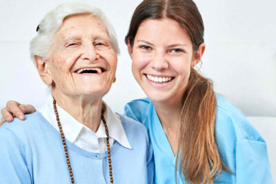 woman and elderly woman smiling