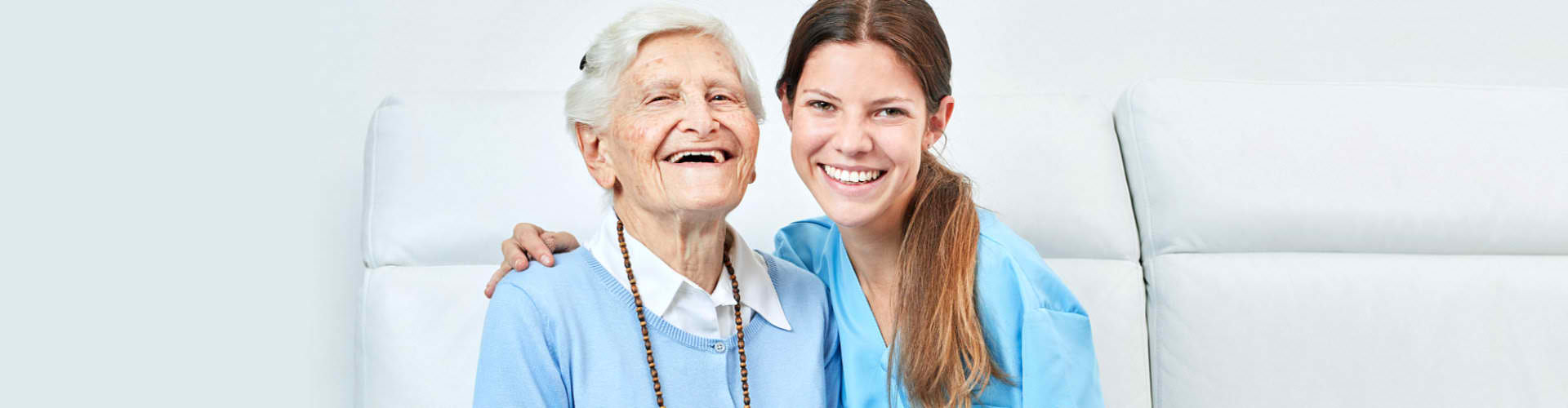 woman and elderly woman smiling