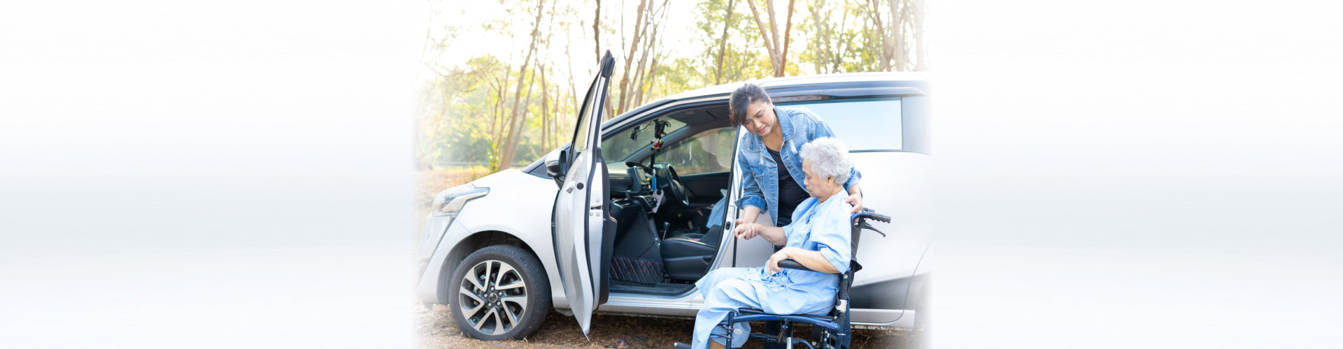 woman helping senior to the car